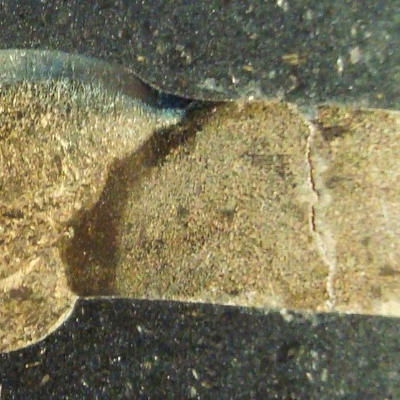 Macrography of a longitudinal section of the flange to pipe weld, cracked in the flange. Pipe thickness, measured, is 5 mm. Flange thickness at the welded region is 7.5 mm. The macro was etched using NaOH solution, electrolytic.