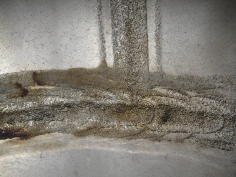 Internal aspect of the 8" diameter pipe that suffered localized thinning and leakage. The vertical weld is the pipe seam and the horizontal weld is the circunferential butt weld.