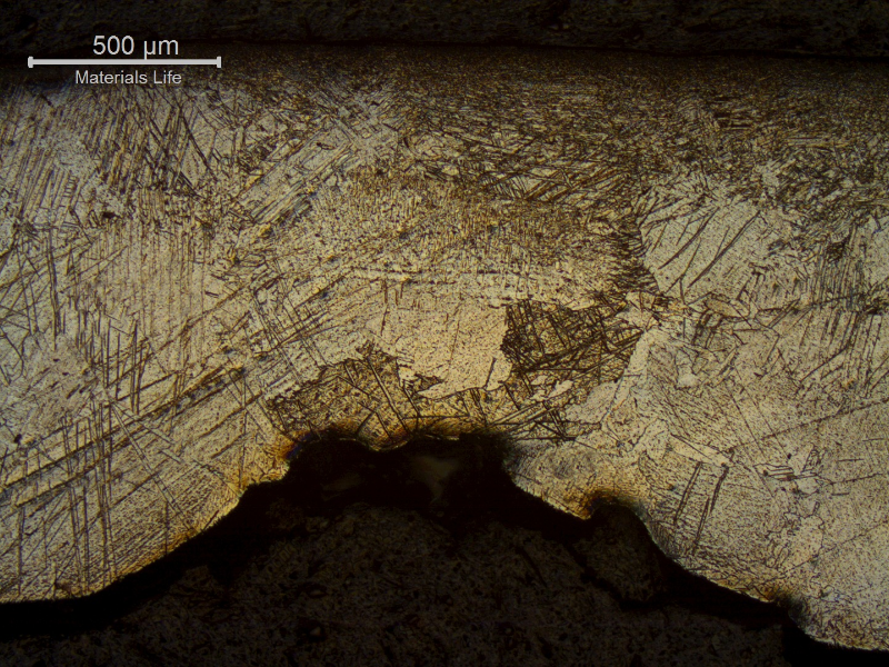 Seam weld of the pipe showing the localized thinning in the weld metal, caused by the detachment of the hydride layer and brittle behaviour of the coarse weld metal structure.