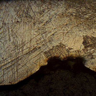 Seam weld of the pipe showing the localized thinning in the weld metal, caused by the detachment of the hydride layer and brittle behaviour of the coarse weld metal structure.