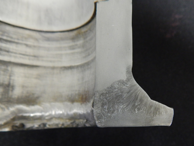 The macro section transverse to the welded region, show that the through wall cracking occurred in the pipe base metal, from the margin of the weld.