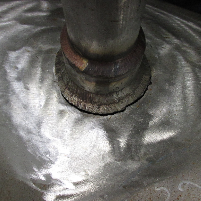 The main pipe, ND 18", has suffered a pipe through wall cracking at the margin of the 1 1/2" branch socket weld.