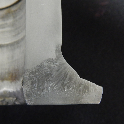 The macro section transverse to the welded region, show that the through wall cracking occurred in the pipe base metal, from the margin of the weld.
