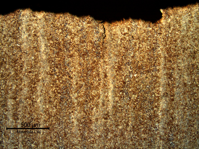 Micrography of a longitudinal section of the pin, at the fracture position, showing a low magnification aspect of the fracture surface (top of the figure) and secondary cracks associated to the segregation band.