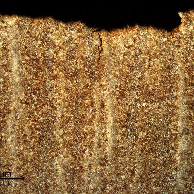 Micrography of a longitudinal section of the pin, at the fracture position, showing a low magnification aspect of the fracture surface (top of the figure) and secondary cracks associated to the segregation band.