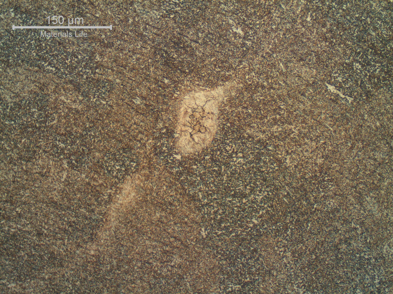 Detail of a region of entrapped carbon from the arc gouging, in the weld metal.