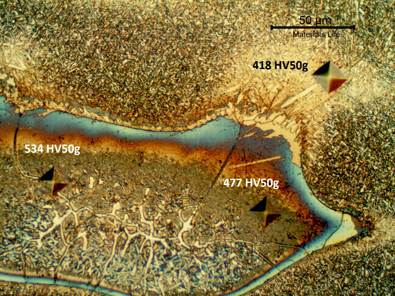 Microhardness identations in the regions of entrapped carbon, showing that in these regions there are carbides and retained austenite.
