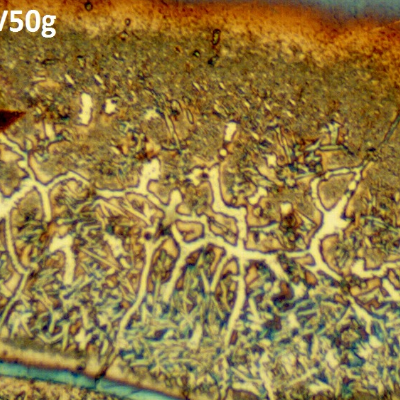 Microhardness identations in the regions of entrapped carbon, showing that in these regions there are carbides and retained austenite.