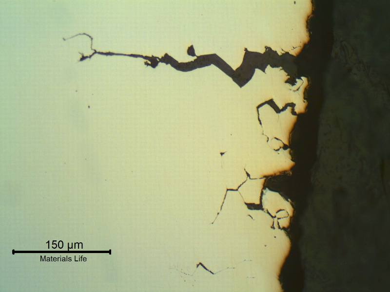 Transverse section of the fitting that suffered a longitudinal cracking. As polished. The wrought fitting has suffered intergranular stress corrosion cracking from the internal surface, exposed to hot caustic environment.