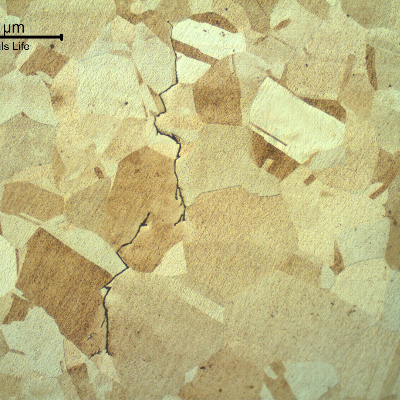 Crack propagation with intergranular and transgranular aspects.