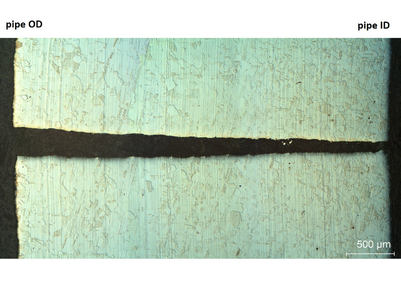 Micrography of a longitudinal section of the pipe (seamless), that shows the through wall cracking, straigth and not associated to any welded region or microstructural problem.