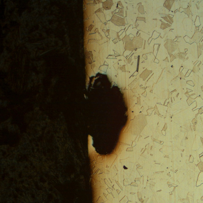 Micrography of the pipe in a longitudinal section, close to the external surface, showing a pit (adjacent to the through wall cracking). The corrosion spt is not associated to any microstructural feature.