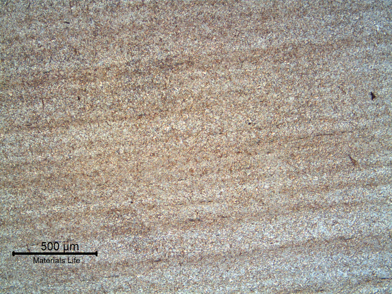 Micrography of a longitudinal section of the mooring chain in the base metal. The low magnification reveals the banded structure of the rolled bar. The base metal microstructure is bainitic..