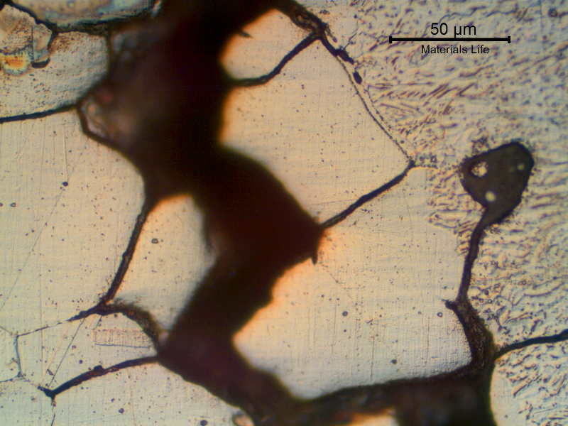 Detail of the fusion line region of the repair weld.  Cracks filled with oxides indicating that the material was already corroded when the bead was deposited.