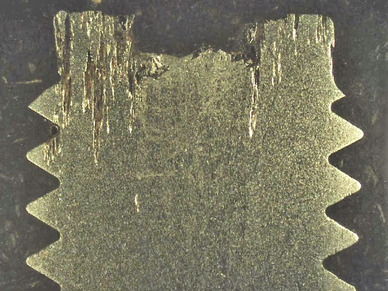 The macrography of the longitudinal section of the pin (9.5 mm nominal diameter) shows the localized corrosion associated to the non metallic inclusions.