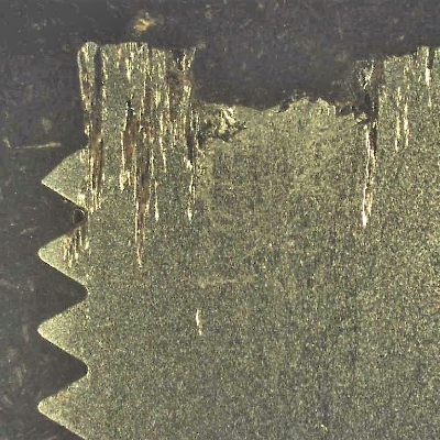 The macrography of the longitudinal section of the pin (9.5 mm nominal diameter) shows the localized corrosion associated to the non metallic inclusions.