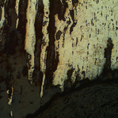 The micrographic detail of the longitudinal section of the pin shows the localized corrosion associated to the non metallic inclusions.