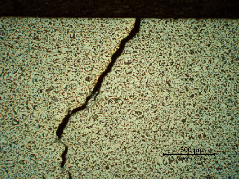 Micrography of the crack at the internal surface of the steam drum. The shell plate presents a ferritic perlitic structure.