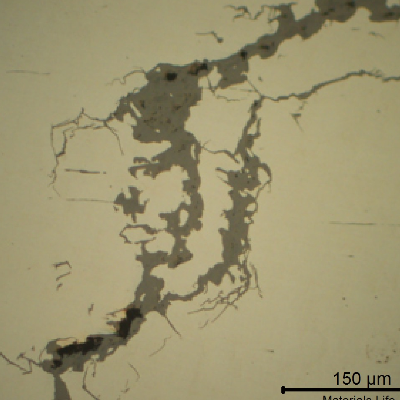 Micrography of a crack, as polished, presenting the cracks filled with corrosion products.