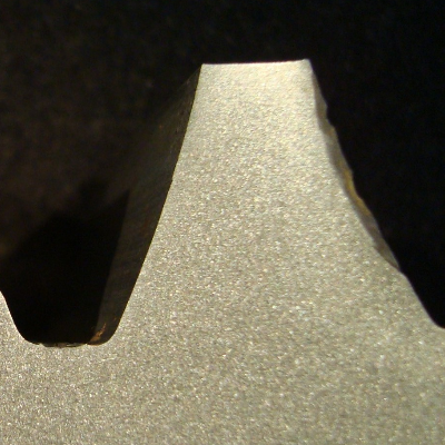 The macrography of the transverse tooth section of the SPUR GEAR shows that the surface is not hardened by any process or treatment.