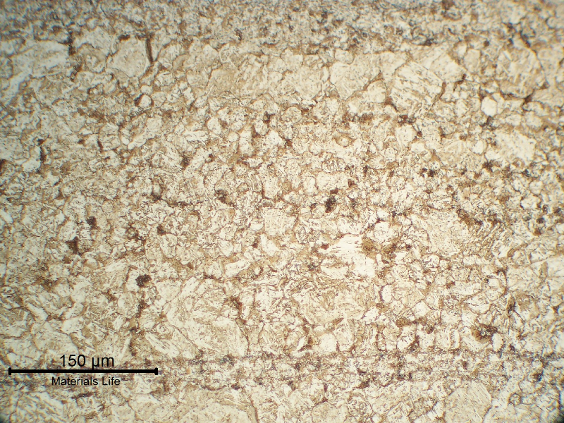 13Cr SS longitudinal section micrography, at the collapsed region, showing a ferritic matrix structure (overtempered) with the previous austenite grain boundaries decorated by phases (carbides and probably martensite islands), indicating that the material was exposed to a high tempering temperature that created a partial austenitizing condition. It explains the material low toughness and lower strenght (than required).