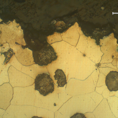 Micrography presenting a detail of the fracture surface opening to the graphite nodules.