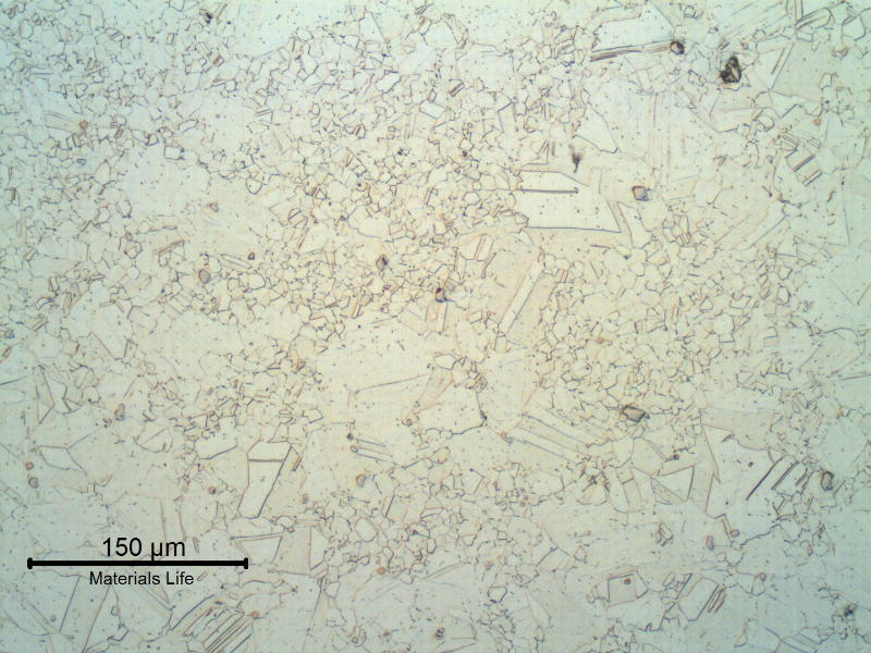 The micrography of a transverse section of the shaft shows a duplex grain size structure in the center of the shaft.  This conditions was probably generated due to the delta phase presented in segregated bands in the center of the original bar.