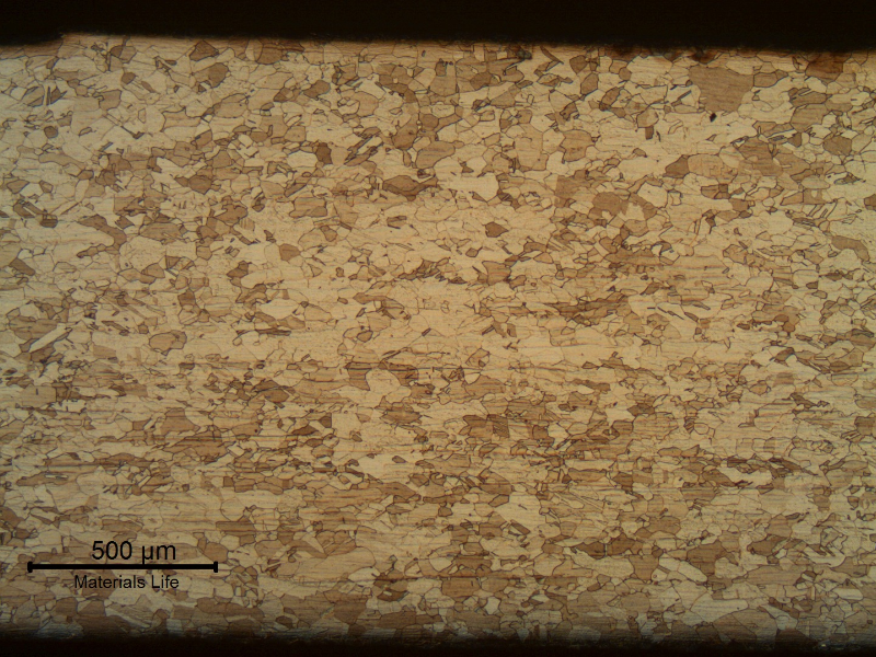 The micrography of the tube shows a granular structure and light deformation lines. No evidences of corrosion from the external surface (upper side of the figure) or internal surface (lower side of the figure).