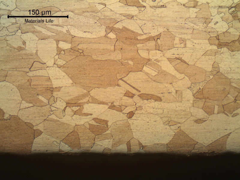 The material structure is similar all through the thickness and there are no evidencies of corrosion at the surfaces.