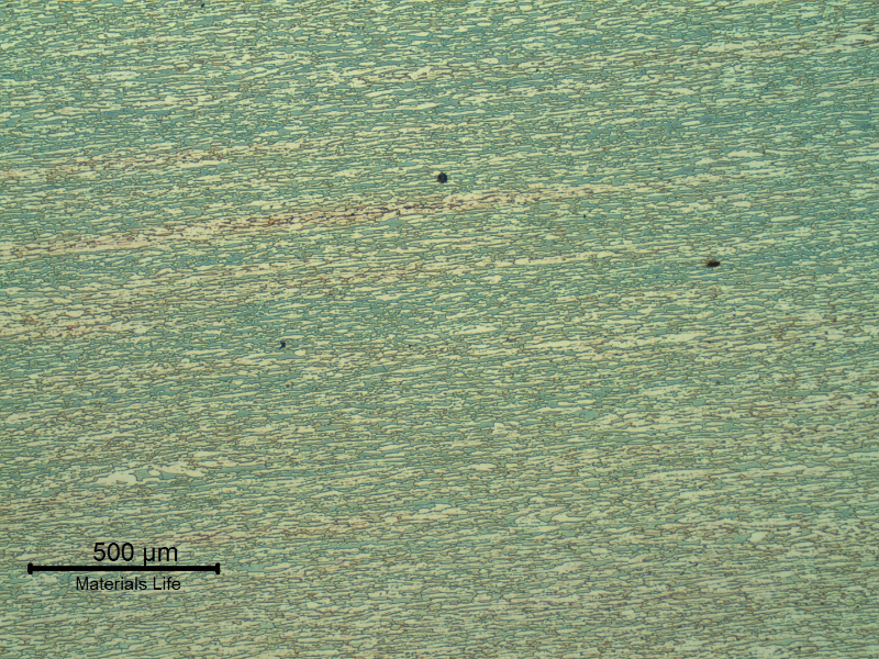 Micrography of the pipe base metal presenting a refined duplex ferritic austenitc structure, banded.