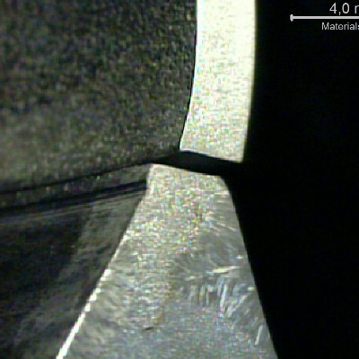 The macrography of a transverse section of the shell to flange weld (Lepto's etch) shows that the cracking occurred through the shell plate thickness, at the margin of the fillet weld.