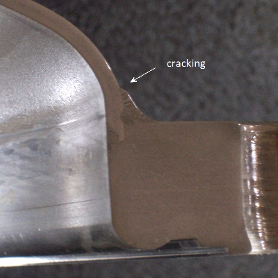 Macrography of the welded joint between the flange and the shell, indicating the position where the cracking   was detected, at 90°.