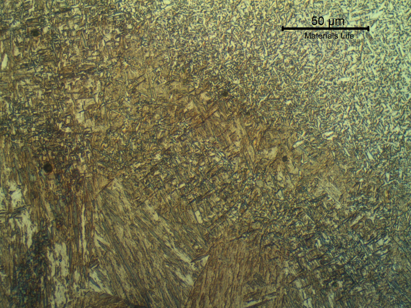 Micrography of the low alloy steel tube at the fusion line, presenting a martensitic structure at the HAZ and acicular ferrite in the weld metal.