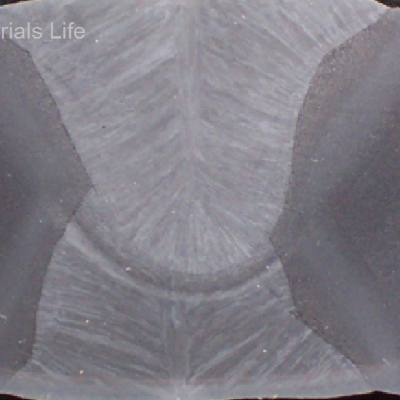 Macrosection transverse to the longitudinal seam weld, presenting the two passes, the first welded from the internal side and the second welded from the external side. It is possible to see the columnar grains of the weld and the heat affected zone (HAZ) from each pass. See the schematic drawing in the next figure