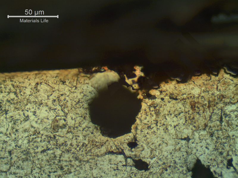 Micrographic aspect of the corrosion damage in a section transverse to the pitting.