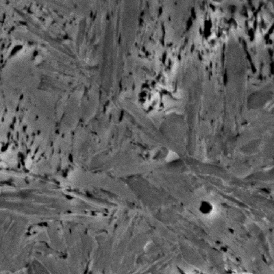 Detail of the tempered martensitic microstructure with secondary carbides of the knife, observed in a transverse section micrography.