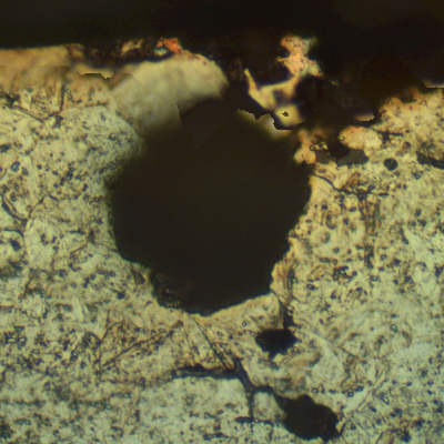 Micrographic aspect of the corrosion damage in a section transverse to the pitting.