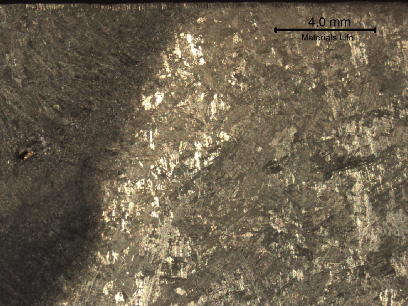 Macrography of a transverse section of the welded joint between the original casting and the inserted casting, in the side of the inserted part.