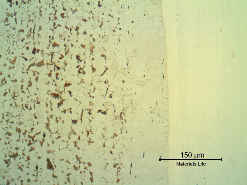 Micrographic detail of the interface in the longitudinal section of the pipe showing the decarburized layer at the solid solution welded interface. The stainless steel structure (in the right side of the figure) is not revealed using the Nital etch.
