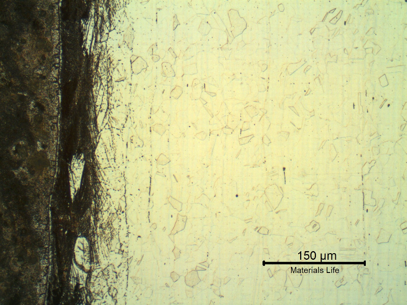 Micrography of the interface between the carbon steel  that is strongly etched by the electrolytic oxalic acid (in the left side of the figure) and the stainless steel, in the longitudinal section of the pipe.  There is a strain hardened layer very close to the interface, at the stainless steel side.