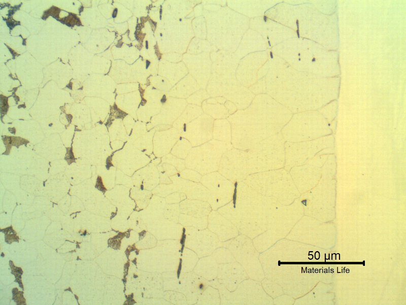 Micrographic detail of the interface in the longitudinal section of the pipe showing the decarburized layer at the solid solution welded interface. The stainless steel structure (in the right side of the figure) is not revealed using the Nital etch.