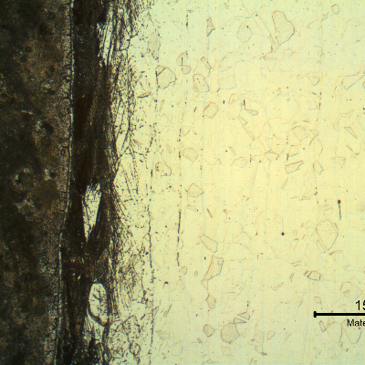 Micrography of the interface between the carbon steel  that is strongly etched by the electrolytic oxalic acid (in the left side of the figure) and the stainless steel, in the longitudinal section of the pipe.  There is a strain hardened layer very close to the interface, at the stainless steel side.