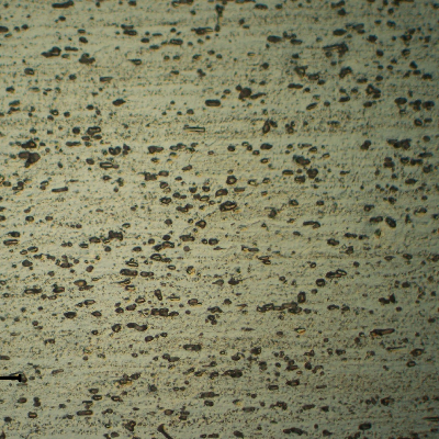 Micrography of a longitudinal section of the pipe AA 3003. Granular structure that reveals the forming direction and dispersed particles.