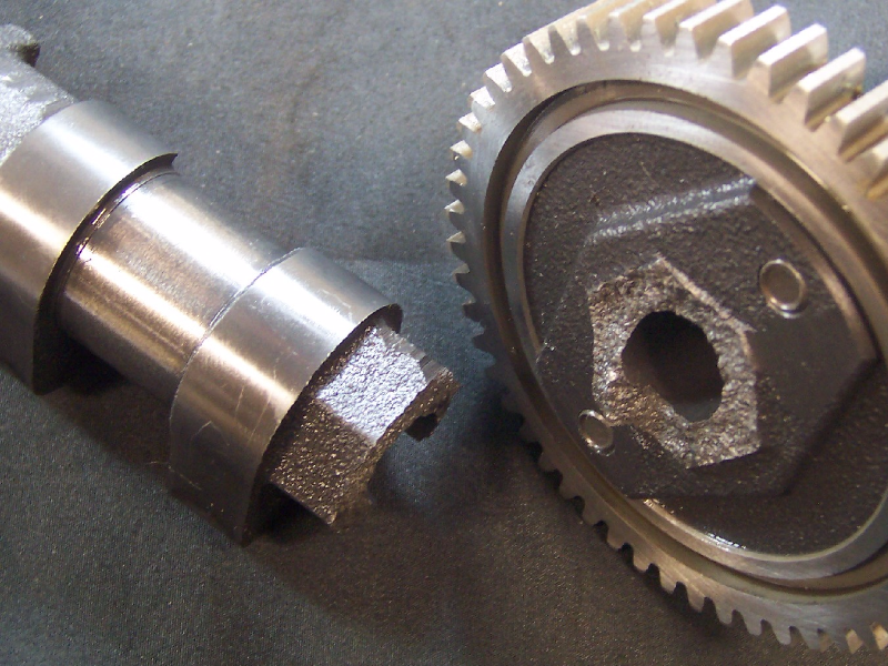 The camshaft broke in a brittle way in a region where the shaft changed the geometry, close to a chilled lobe.