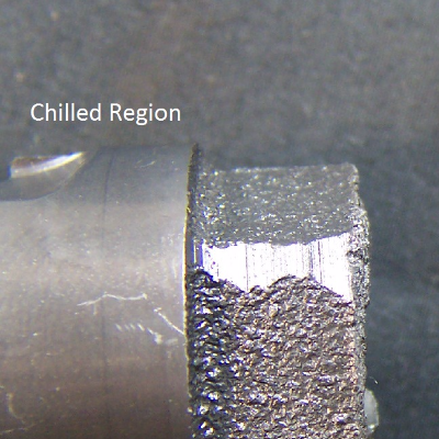 Camshaft in the broken region, close to a lobe where the cast iron was chilled.