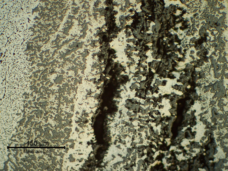 Through wall cracking in the longitudinal seam weld of the fitting.  Several cracks, longitudinal to the weld, were created by the connection of voids in the weld metal, associated to a strong microstructural evolution.
