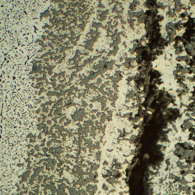 Through wall cracking in the longitudinal seam weld of the fitting.  Several cracks, longitudinal to the weld, were created by the connection of voids in the weld metal, associated to a strong microstructural evolution.
