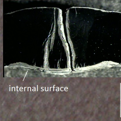 Aspect of the internal side of the fitting, at the longitudinal seam weld, and macrography of a transverse section showing the through wall cracks.