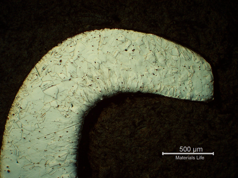 Micrography of the nut in the longitudinal direction, at the Nylon insert position, showing a cold formed region at the end of the nut, with high hardness levels (about 600 HV100g).