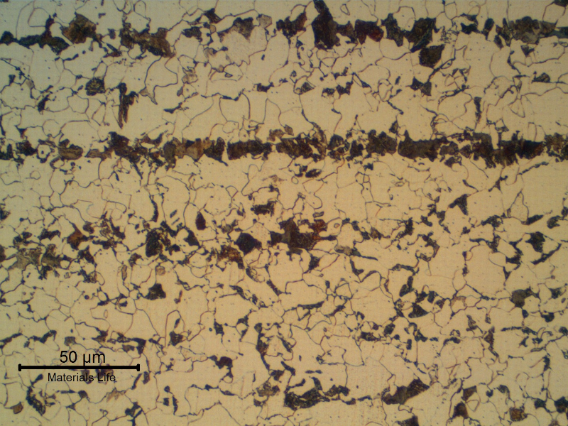 Micrography of a longitudinal section of the 1" plate, in the center of the thickness, presenting a refined ferritic perlitic microstructure. Banded.